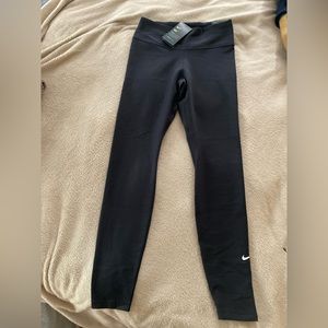 Women’s size Medium The Nike One Tight Fit. Full length Mid Rise Black Pants